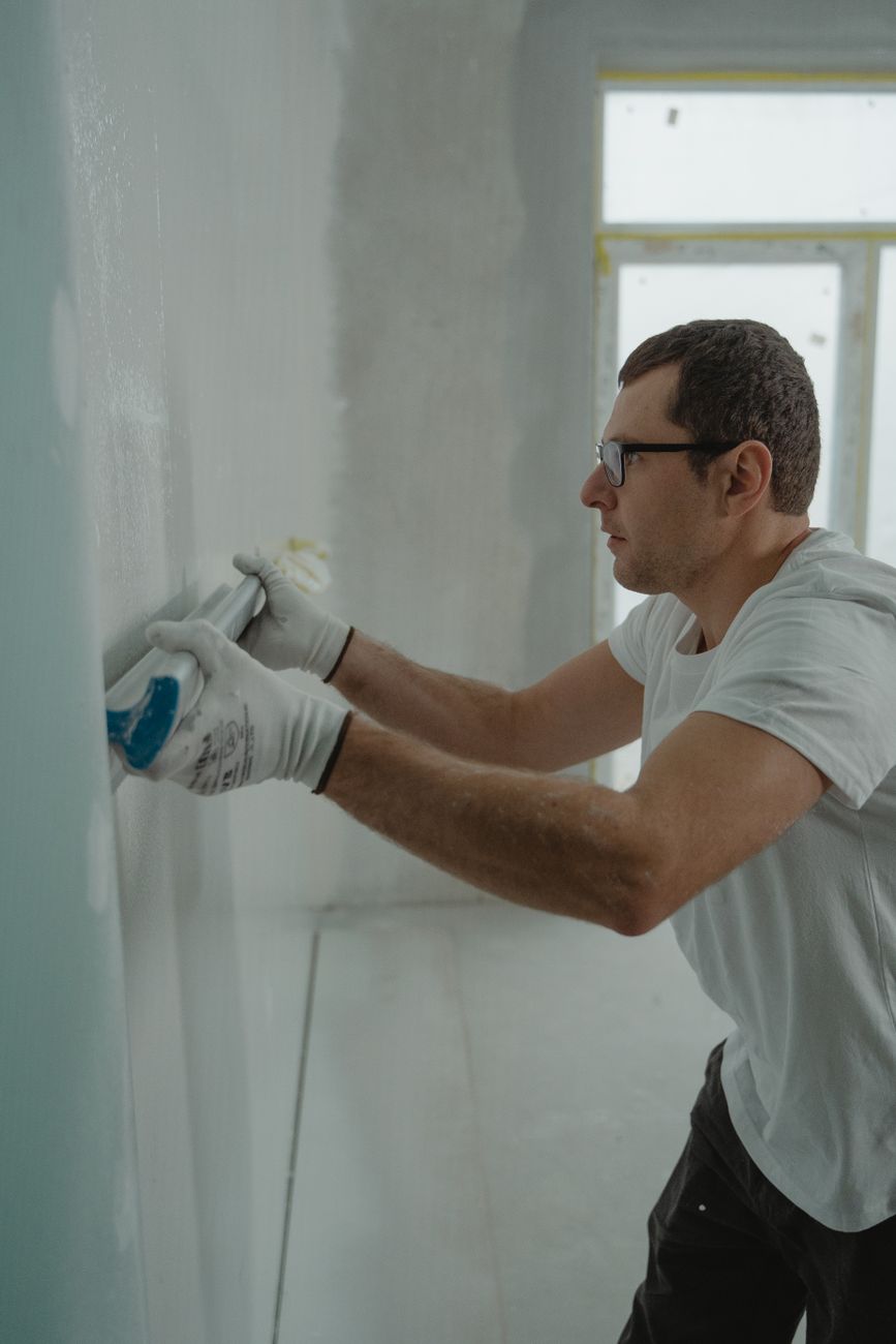 Portrait of a man in a work shirt in a workshop doorway